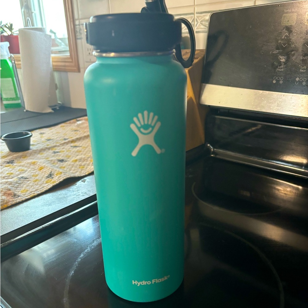 Aqua 40oz Hydroflask wide mouth water bottle.